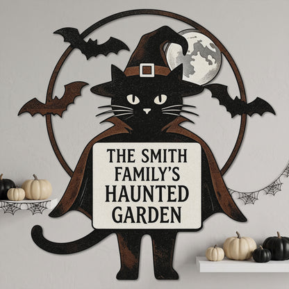 Witch cat garden stake among autumn leaves