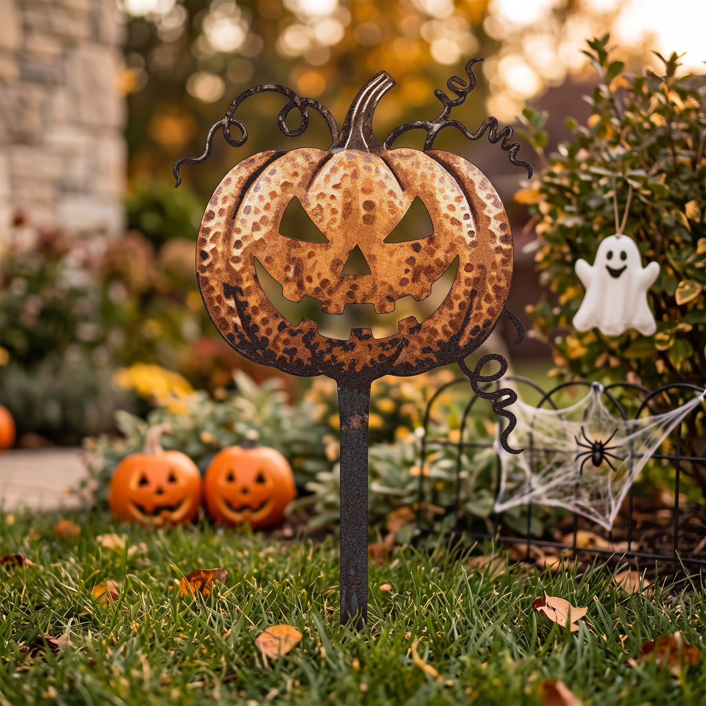 Rusted Jack-O-Lantern Pumpkin Garden Stake in a garden