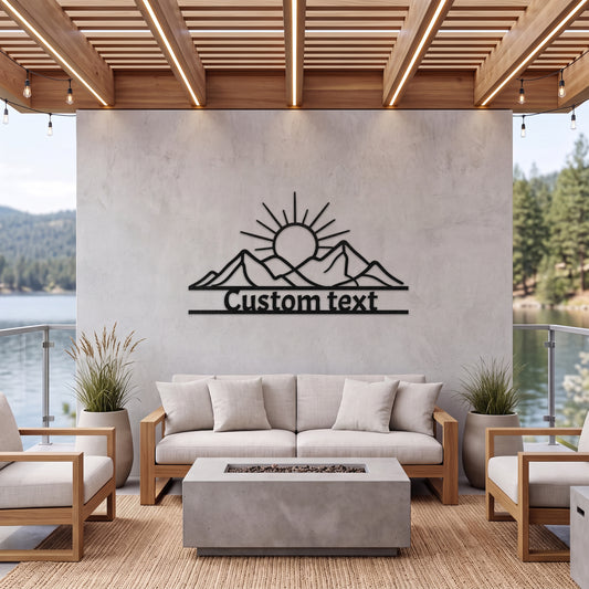 Black mountain sunrise metal sign on a covered patio